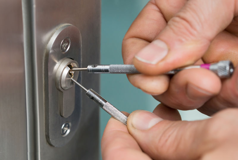 Locksmith picking a lock for a business that is locked out