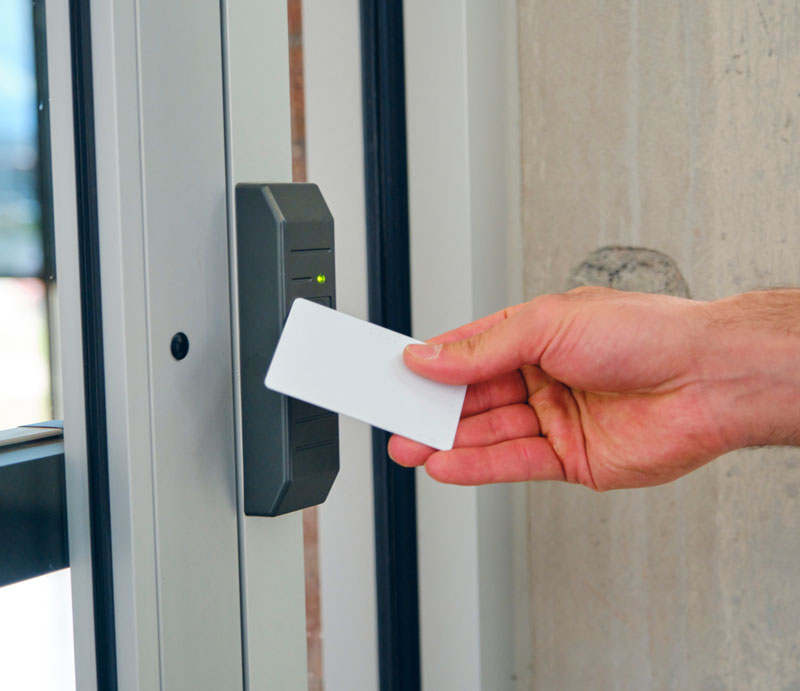 some one using a key Card on a electronic lock