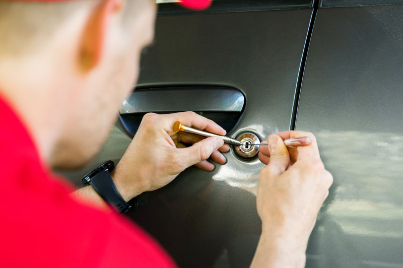 Locksmith picking a car lock